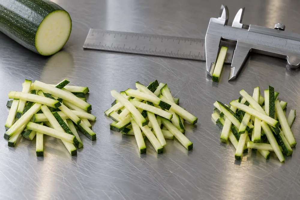 Three samples of zucchini strips beside measuring tools